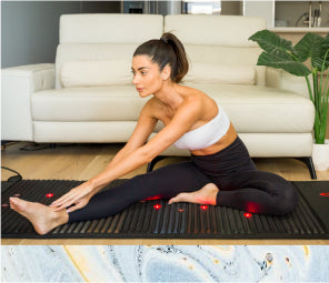 Woman stretching on a PEMF Mat